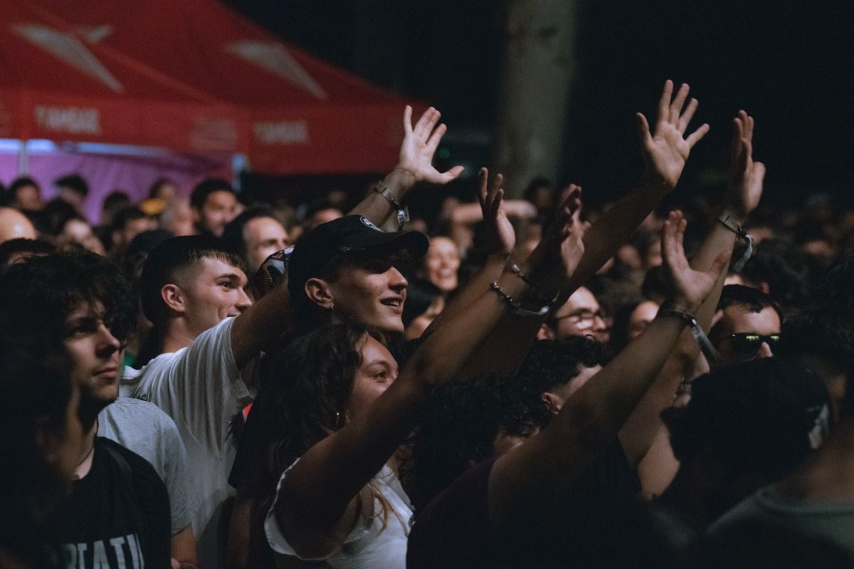 Audience enjoying a night-time outdoor music event.