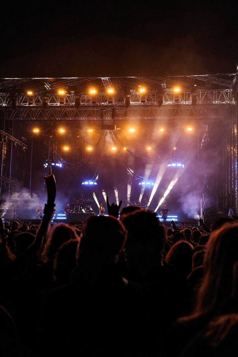 Concert stage, lighting and audience at night.